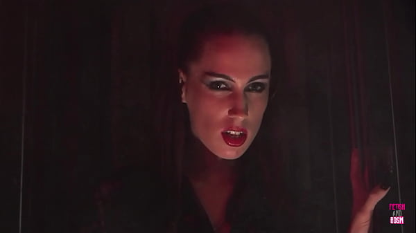 Two lesbian vampires experience intense orgasms while penetrating each other with a large dildo