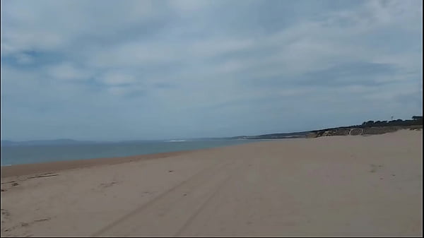 Guy on nude beach spills a lot of milk